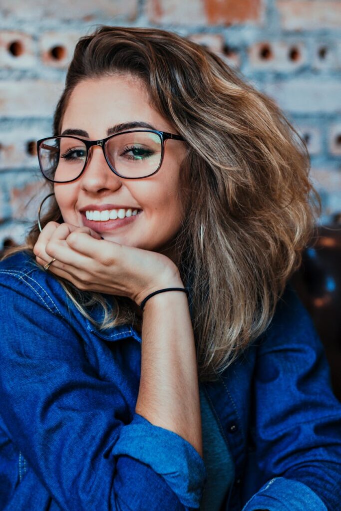 closeup photo of smiling woman wearing blue denim jacket